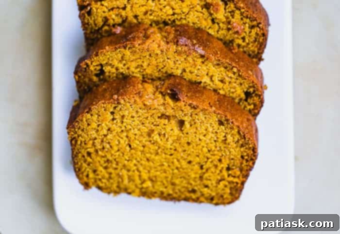 Starbucks Pumpkin Pound Cake Copycat Recipe 5 Two generous slices of homemade Starbucks Pumpkin Bread on a white plate