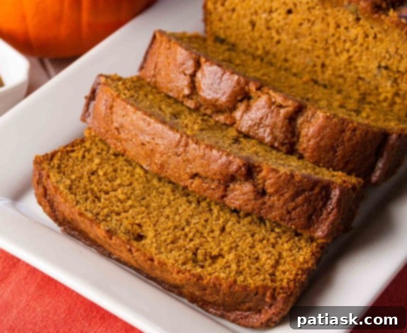 20 Pumpkin Bread Masterpieces for Autumn 3 A perfectly baked loaf of classic pumpkin bread, showcasing its rich, golden-brown crust and inviting texture.