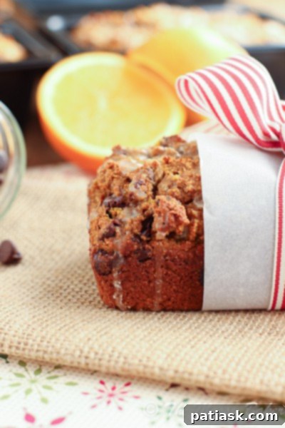 20 Pumpkin Bread Masterpieces for Autumn 6 Moist pumpkin bread infused with orange zest and chocolate chips, drizzled with a bright orange glaze.