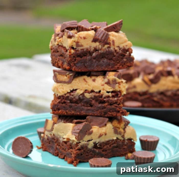 Decadent Reese's Peanut Butter Brownies 8 Reese's Peanut Butter Cup Brownies on a white plate, close up.
