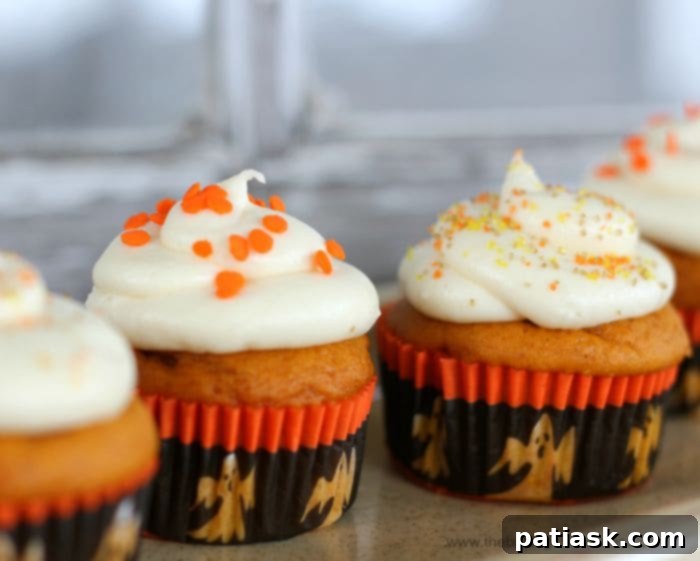 Plush Pumpkin Cupcakes with Vanilla Cream Cheese Frosting - a harvest season delight