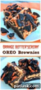 Decadent Orange ButterScream Oreo Brownies 5 Two Orange Buttercream Oreo Brownies with a bite taken out of one, showing the layers.