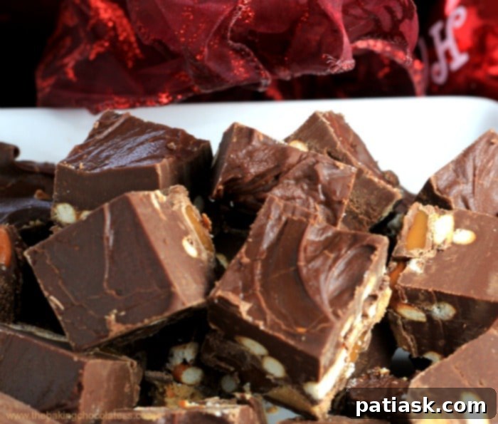 Sweet and Salty Rolo Reese's Pretzel Fudge 3 Close-up of Rolo Reeses PB Pretzel Fudge squares, showcasing the pretzel and candy bits.