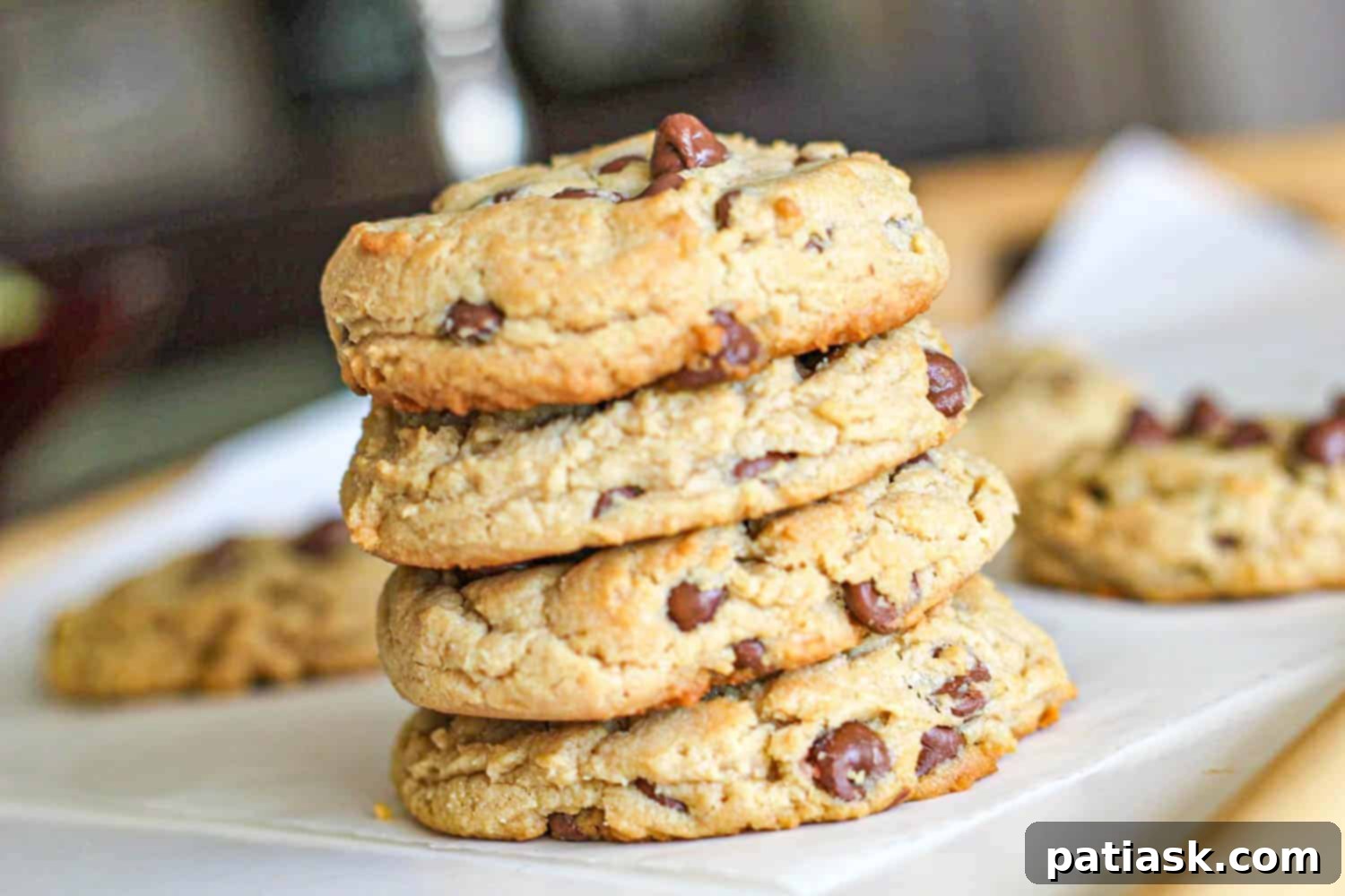 Indulgent Thick Milk Chocolate Chip Peanut Butter Cookies 5 Perfectly baked Milk Chocolate Chip Peanut Butter Cookies on a cooling rack