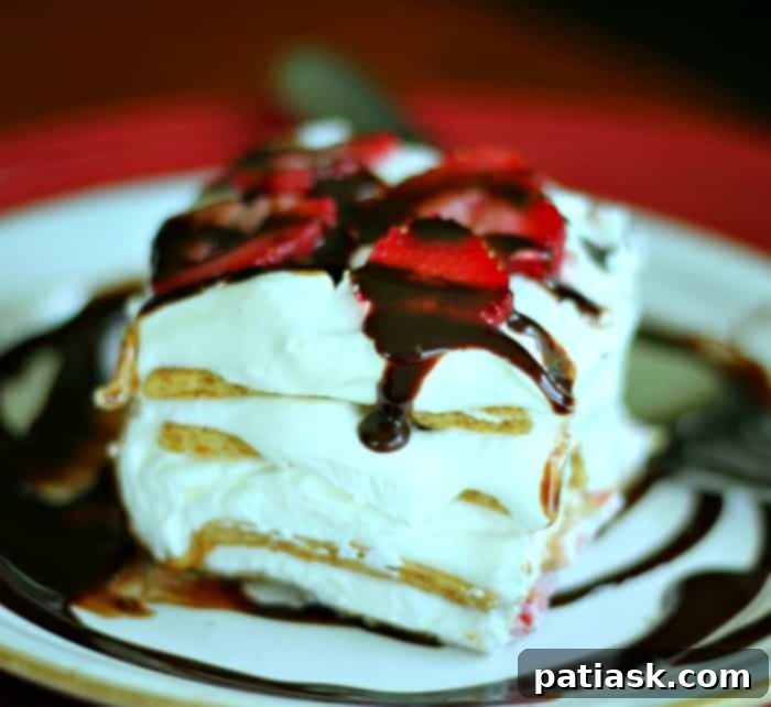 Luscious Strawberry Eclair Delight 5 Prepared No-Bake Strawberry Eclair Cake topped with fresh strawberries and chocolate drizzle, ready to serve