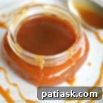 Your New Favorite Salted Caramel Sauce 7 Homemade salted caramel sauce in a jar with a spoon
