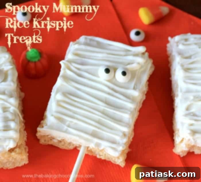 20 Hauntingly Delicious Halloween Treats 9 Spooky Mummy Rice Krispie Treats decorated with white chocolate and candy eyes.