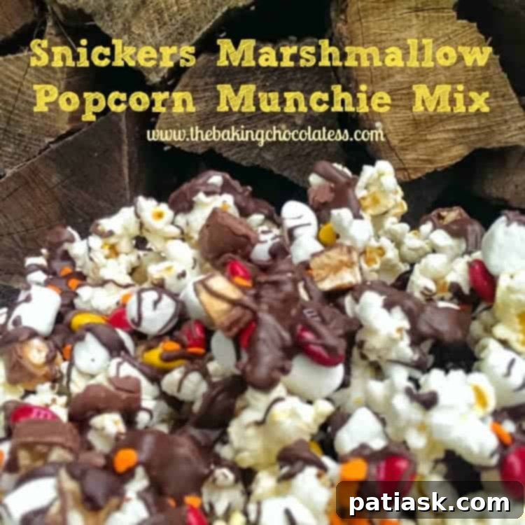 20 Hauntingly Delicious Halloween Treats 14 Snickers Marshmallow Popcorn Munchie Mix in a bowl.