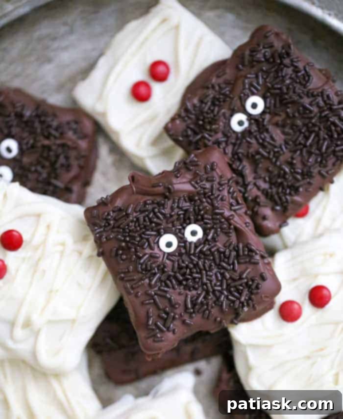 20 Hauntingly Delicious Halloween Treats 16 Monster and Mummy Chocolate Covered Graham Crackers with colorful frosting.