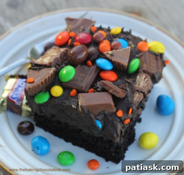 20 Hauntingly Delicious Halloween Treats 4 Halloween Black Magic Candy Cake topped with various candies.