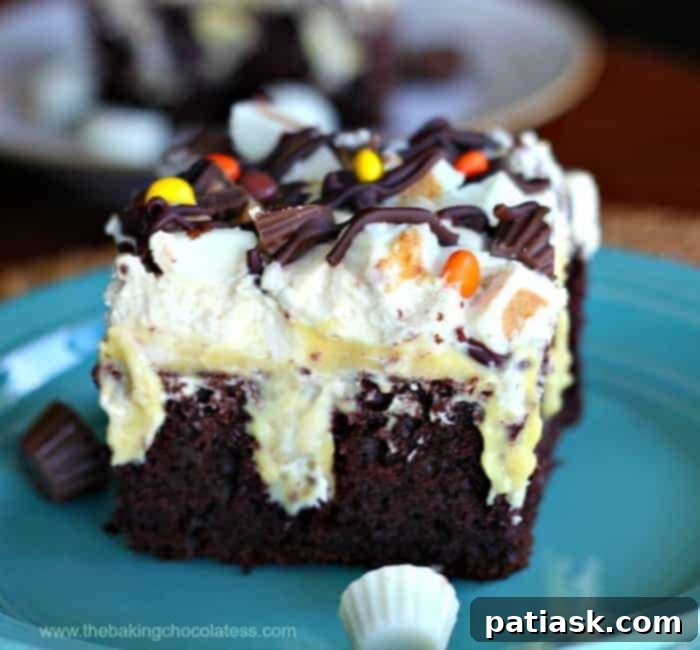 20 Hauntingly Delicious Halloween Treats 8 Reese’s Peanut Butter Devil’s Food Chocolate Poke Cake with peanut butter cups.
