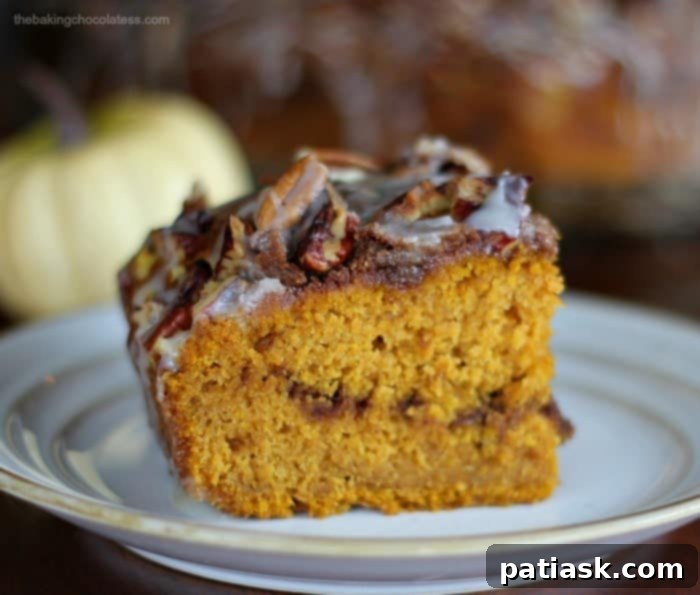 Indulgent Pumpkin Pecan Coffee Cake with Brown Butter Glaze 4 Close-up of a slice of Pumpkin Pecan Coffee Cake showing the moist crumb and streusel layers.