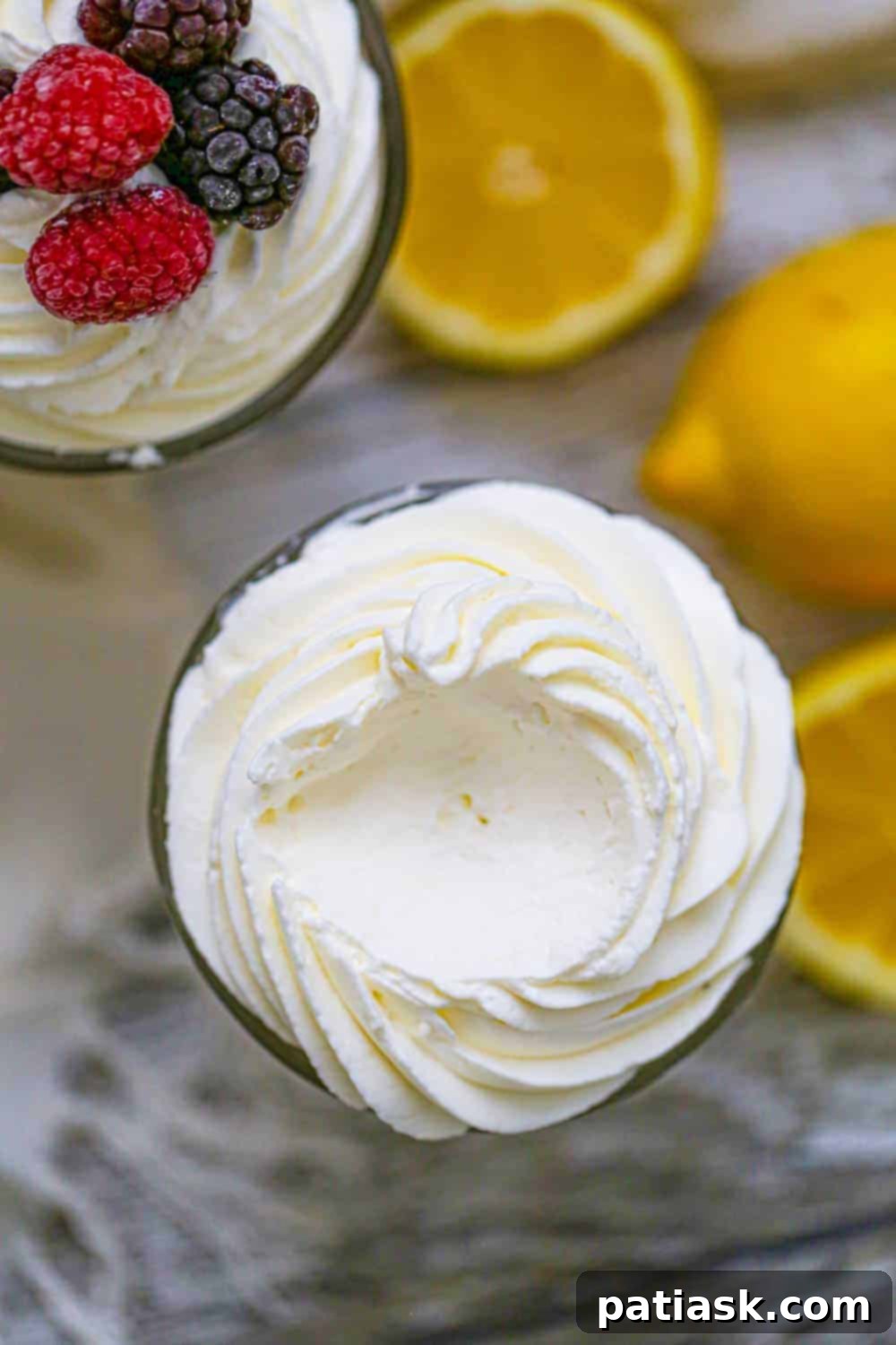 Cloud-Like Keto Lemon Mousse 4 Individual serving of Keto Fluffy Lemon Burst Mousse with a berry garnish