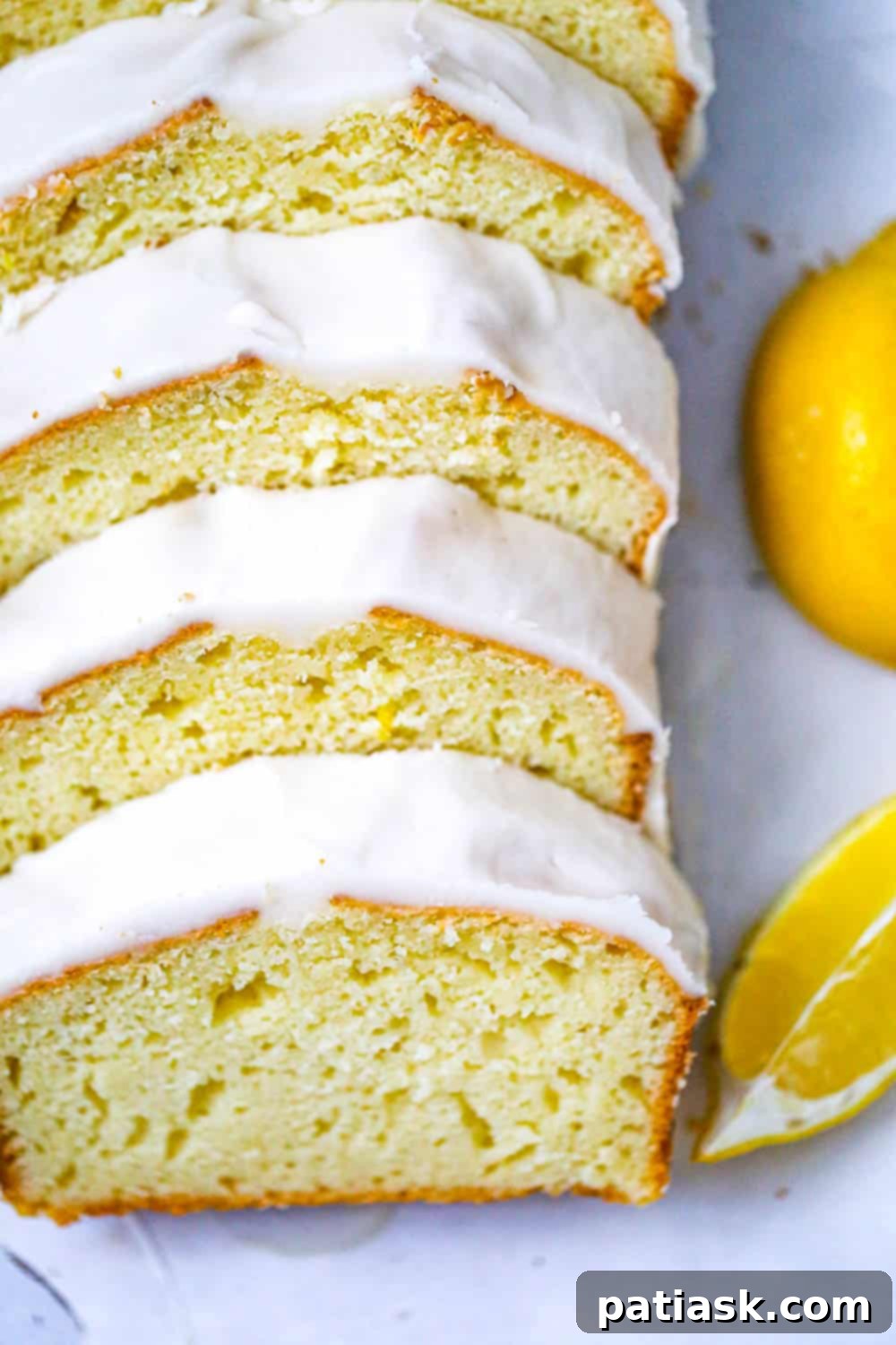 Starbucks-Inspired Glazed Lemon Loaf 3 Starbucks CopyCat Lemon Loaf recipe - A close-up of a slice of homemade lemon loaf showing its tender crumb and glistening glaze.