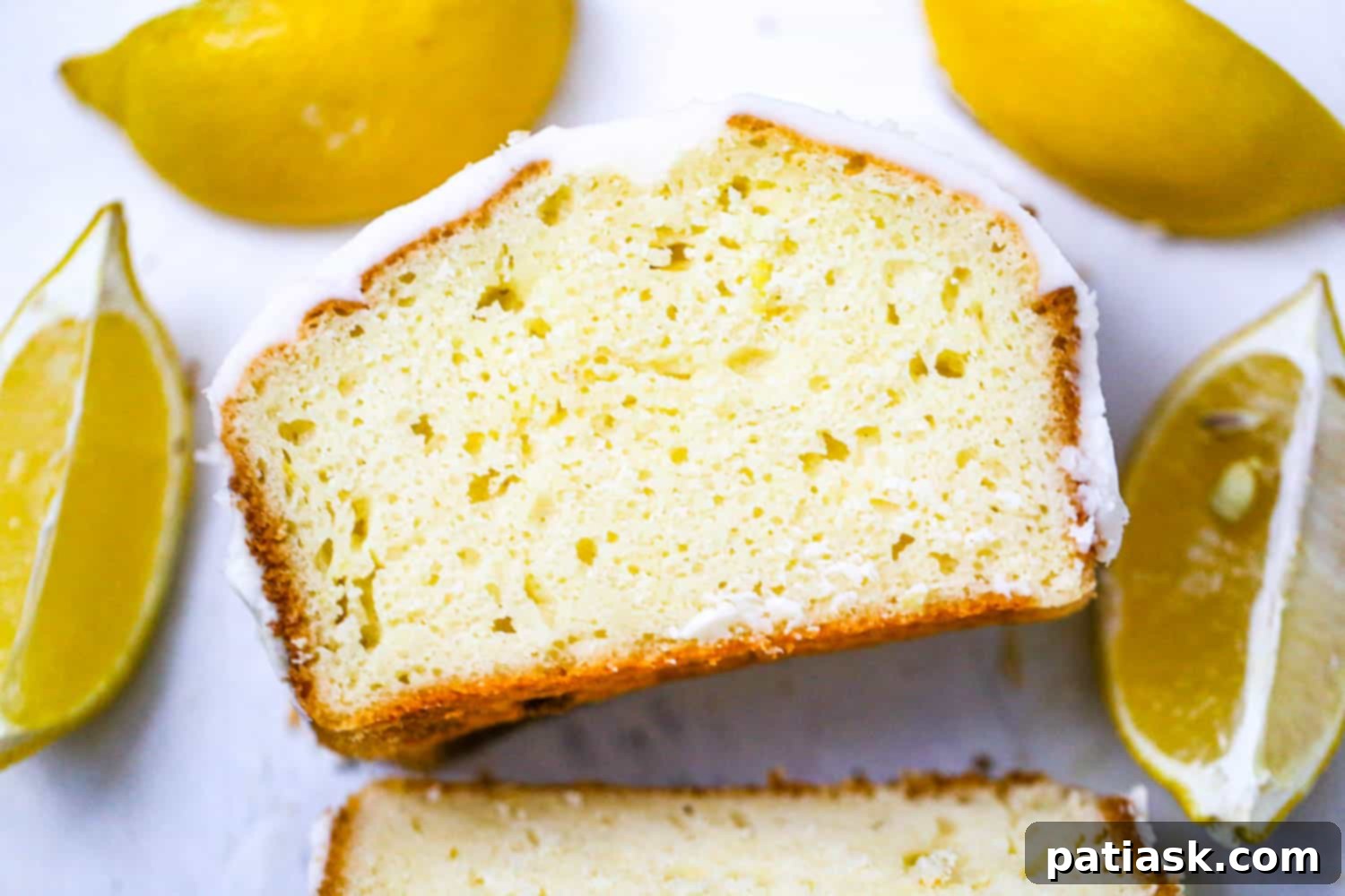 Starbucks-Inspired Glazed Lemon Loaf 7 Best Lemon Loaf - easy lemon loaf recipe - A close-up overhead shot of a perfectly sliced lemon loaf, showing its moist interior.