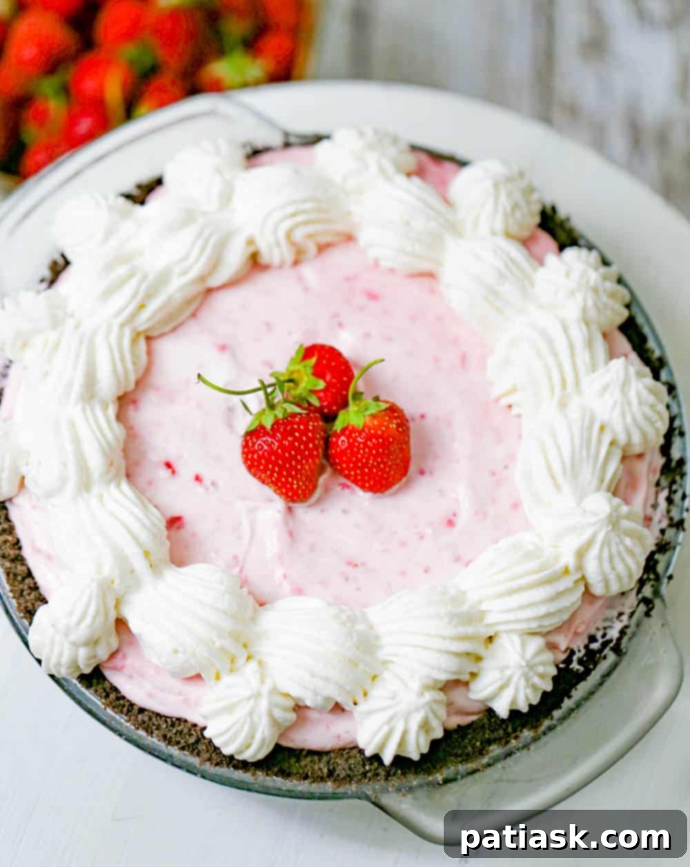 Strawberry Dream Cheesecake 2 Frozen dessert with strawberries and whipped cream on a chocolate cookie crust