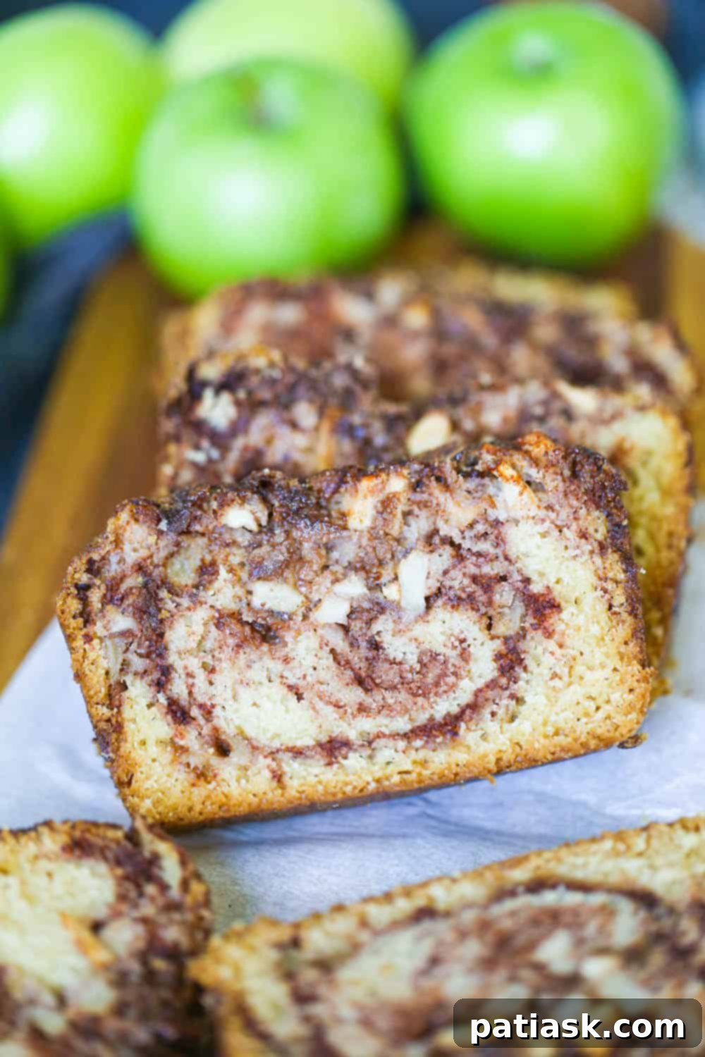 Spiced Apple Cinnamon Bread 3 Slices of fluffy cinnamon apple bread with a swirl of spice, ready to eat.