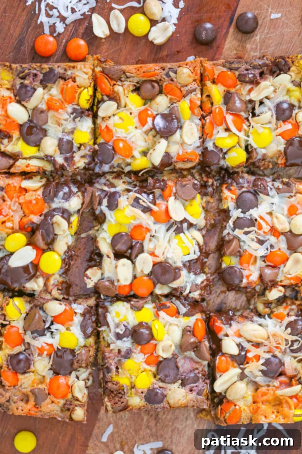 Reese's Pieces Peanut Butter Dream Bars 6 Reese's Pieces Magic Bars stacked on a white plate