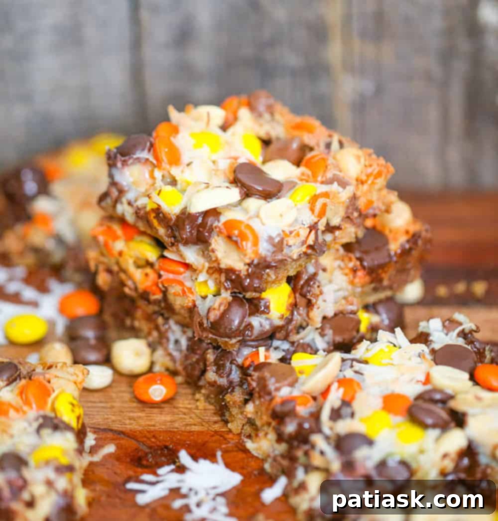 Reese's Pieces Peanut Butter Dream Bars 3 Close-up of Reese's Pieces Magic Bars on a wooden cutting board