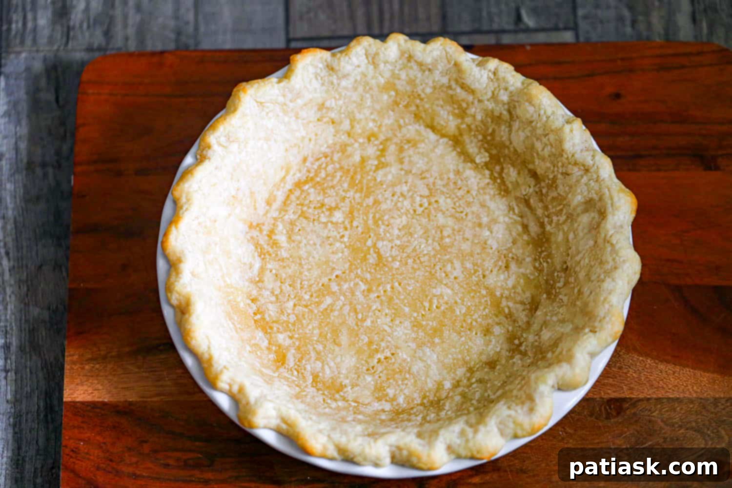 Tutorial image showing how to blind bake a pie crust