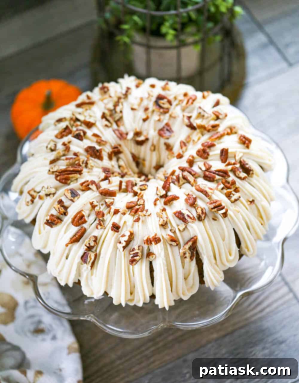 Full view of a beautifully frosted Pumpkin Bundt Cake on a serving platter
