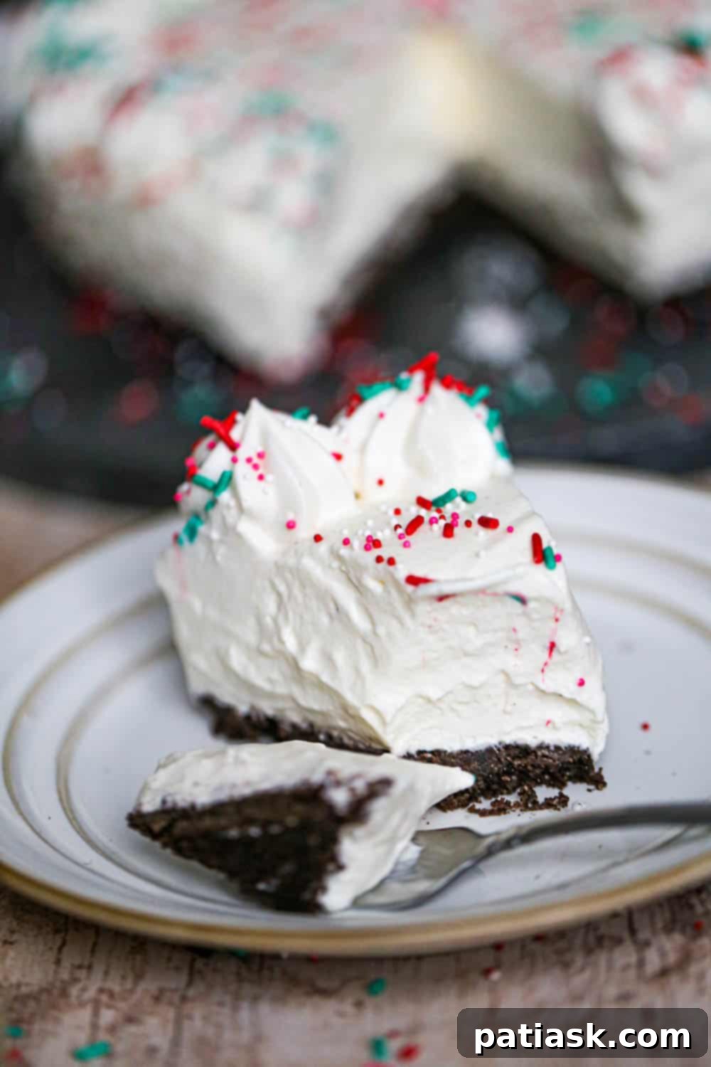 Simple Spiced Eggnog Cheesecake 5 Easy Eggnog Cheesecake with a bite taken out, showing the creamy texture