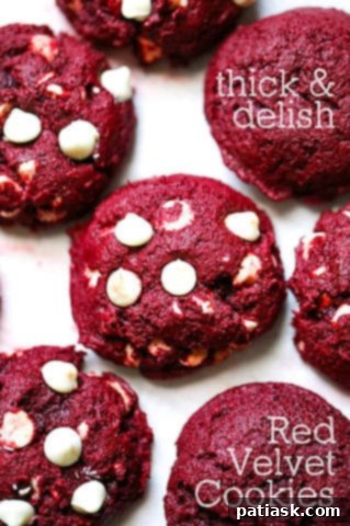 A stack of three thick red velvet cookies
