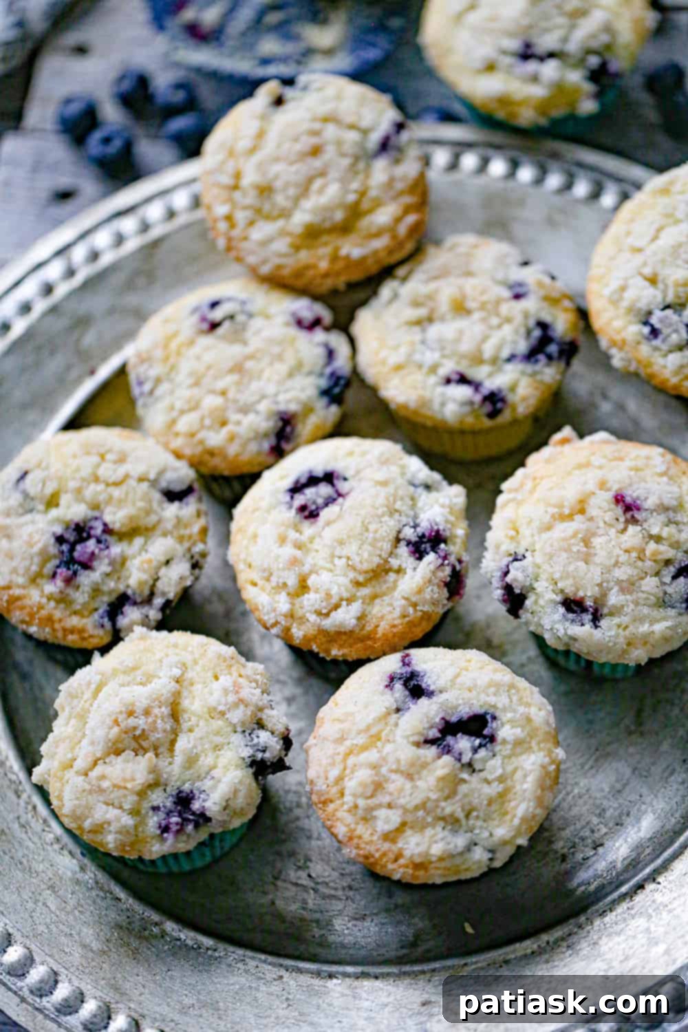 Decadent Blueberry Cream Cheese Muffins 6 Blueberry Cream Cheese Muffins on a platter, ready to be served.