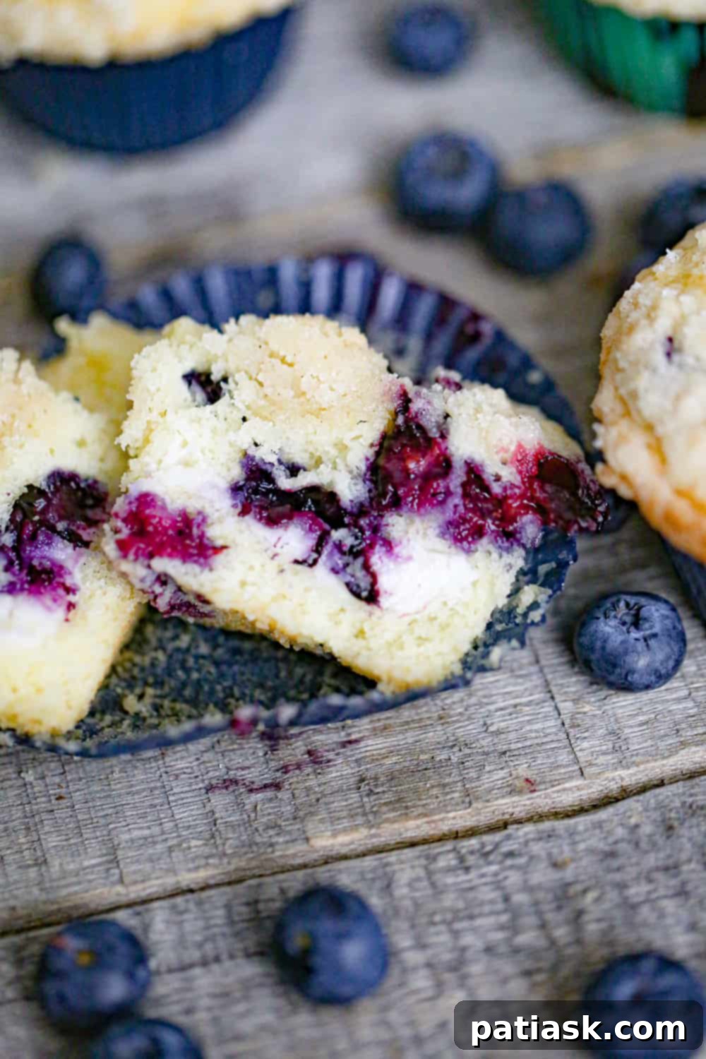 Decadent Blueberry Cream Cheese Muffins 3 Blueberry Cream Cheese Muffins with a visible cream cheese filling!