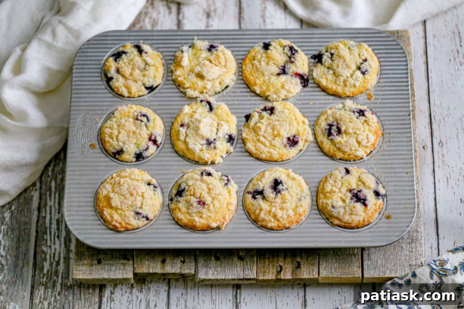 Decadent Blueberry Cream Cheese Muffins 5 Blueberry Cream Cheese Muffins on a cooling rack.