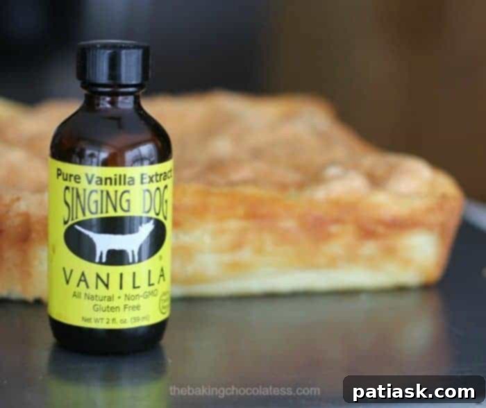 Vanilla's Layered Custard Dream 4 Overhead shot of a beautifully baked Very Vanilla Magic Custard Cake with a dusting of powdered sugar