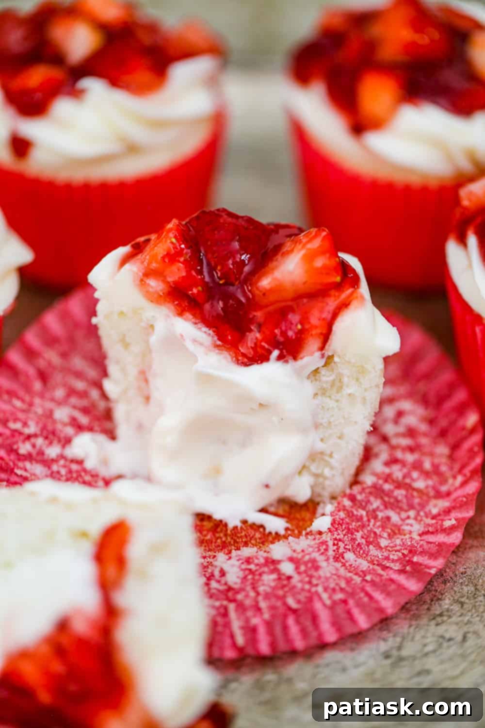 Strawberry Shortcake Cupcakes Made Simple 3 Close-up of Strawberry Shortcake Cupcakes showing the creamy filling and fresh strawberry topping.