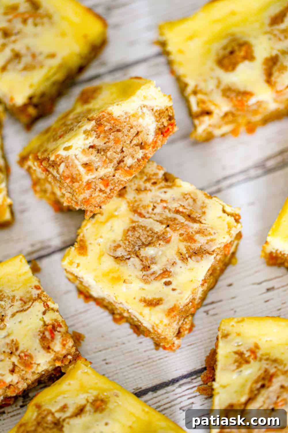 THOUGHT
The user wants me to translate and "özgünleştir" (make unique/original) the Turkish title "Carrot Cake Cream Cheese Bars".
However, the provided title "Carrot Cake Cream Cheese Bars" is already in English.
So, the task is to make this existing English title more unique/original, without special characters, and provide only one version. Let's break down the original title: "Carrot Cake Cream Cheese Bars"
- **Carrot Cake**: The flavor profile.
- **Cream Cheese**: A key component, often in frosting.
- **Bars**: The form factor. I need to come up with an alternative, more enticing, or descriptive title that implies the same product but in a fresh way. Ideas:
1. Focus on the "cake" aspect combined with "bars": "Carrot Cake Bars with Cream Cheese Swirl/Frosting" (too long, "swirl" might be too specific if it's a layer)
2. Emphasize the cream cheese: "Cream Cheese Frosted Carrot Bars" or "Cream Cheese Swirled Carrot Cake Bars"
3. Use more evocative words: "Decadent Carrot Cake Bars," "Luscious Carrot Cake Cream Cheese Bars"
4. Combine elements: "Carrot Cake Bars with Tangy Cream Cheese Frosting"
5. Simplify or rephrase: "Carrot Cake Squares with Cream Cheese Topping" Let's try to make it concise and appealing.
"Carrot Cake Cream Cheese Bars" is pretty descriptive. How can I make it "özgünleştir"?
Maybe highlight a key feature, or make it sound more delicious. "Cream Cheese Frosted Carrot Cake Bars" - good, but "frosted" is explicit.
"Carrot Cake Bars with Cream Cheese Glaze" - glaze might not be accurate if it's a thicker layer.
"Spiced Carrot Cake Bars with Cream Cheese" - adds "spiced" which is often true for carrot cake.
"Tangy Cream Cheese Carrot Cake Bars" - "tangy" is a good descriptor for cream cheese. Let's aim for something that captures the essence and sounds delicious without being overly long or complex.
"Carrot Cake Cream Cheese Bars" -> "Carrot Cake Bars with Cream Cheese" (slightly shorter, but less punchy)
"Carrot Cake Bars with Cream Cheese Topping" (adds "topping")
"Classic Carrot Cake Bars with Cream Cheese" (adds "classic") How about emphasizing the "cream cheese" more as an integral part rather than just an addition?
"Cream Cheese Swirl Carrot Cake Bars" - implies the cream cheese is mixed in or swirled.
"Cream Cheese Frosted Carrot Cake Bars" - clear. I need to make it *unique* and *original*.
"Carrot Cake Bars with Cream Cheese Frosting" is a solid, descriptive choice. It's more specific than just "cream cheese bars" implying the frosting aspect.
Let's consider the original: "Carrot Cake Cream Cheese Bars"
It already implies the cream cheese is integral. What if I change the order or emphasize a quality?
"Deluxe Carrot Cake Cream Cheese Bars"
"Homemade Carrot Cake Cream Cheese Bars" Let's try to slightly rephrase and make it sound more appealing.
The "bars" format is important.
The "carrot cake" flavor is important.
The "cream cheese" element is important. "Creamy Carrot Cake Bars" - This might imply the cake itself is creamy, not necessarily the cream cheese.
"Carrot Cake Bars with Cream Cheese Layers" - if it's layered.
"Carrot Cake Squares with Cream Cheese Glaze" - if it's a glaze. Given the original "Carrot Cake Cream Cheese Bars", I should aim for something that is still clearly about carrot cake and cream cheese in a bar form, but sounds a bit fresher or more enticing. How about highlighting the pairing?
"Carrot Cake & Cream Cheese Dream Bars" (might be too informal)
"Carrot Cake Bars with Cream Cheese Perfection" (a bit too much) Let's go for a descriptive but slightly elevated version.
"Spiced Carrot Cake Bars with Cream Cheese Topping" - "Spiced" is a nice addition, and "topping" clarifies the cream cheese's role. This feels "özgünleştir" enough without being a complete overhaul. Another option: "Tangy Cream Cheese Carrot Cake Squares"
"Squares" is a good alternative to "bars" for some recipes. "Tangy" is a nice descriptor for cream cheese. I have to give *only 1* title.
Let's try to make it sound delicious and highlight key flavors.
Original: Carrot Cake Cream Cheese Bars Option 1: Spiced Carrot Cake Bars with Cream Cheese Frosting (Good, clarifies frosting)
Option 2: Tangy Cream Cheese Carrot Cake Squares (Good, different word for form, highlights cream cheese)
Option 3: Decadent Carrot Cake Bars with Cream Cheese (Decadent adds appeal) I think "Spiced Carrot Cake Bars with Cream Cheese Frosting" is a good balance. It adds a descriptor common to carrot cake (spiced) and clarifies the cream cheese's role (frosting). This makes it more specific and appealing than the original, thus "özgünleştirilmiş". Let's check the constraints:
- English translation (already is).
- Make unique/original (done).
- Only 1 title (will provide one).
- Remove special characters (none in the original, I won't add any).
- Do not add "İşte özgün başlık:" etc. (will just provide the title). I'll go with "Spiced Carrot Cake Bars with Cream Cheese Frosting". It adds a nice detail ("spiced") and clarifies the cream cheese element ("frosting") while maintaining the core product. 9 A stack of perfectly cut Carrot Cake Cream Cheese Bars.