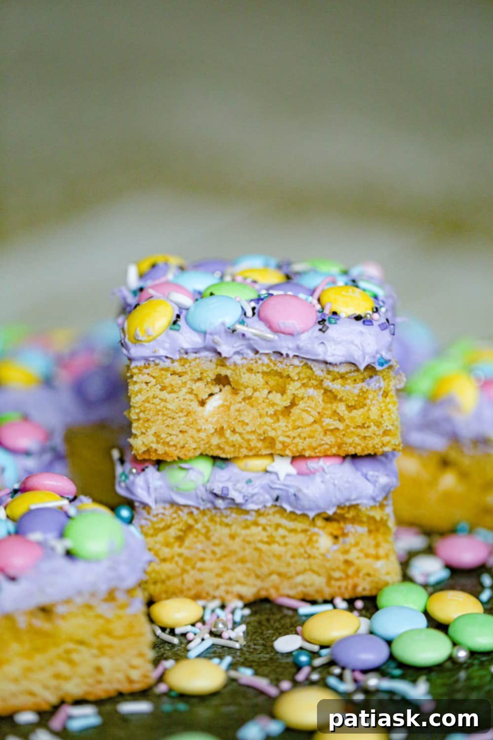 Close-up of Mermaid Cookie Bars showcasing their pastel M&M's, shimmering sugar, and creamy frosting, ready for a party.