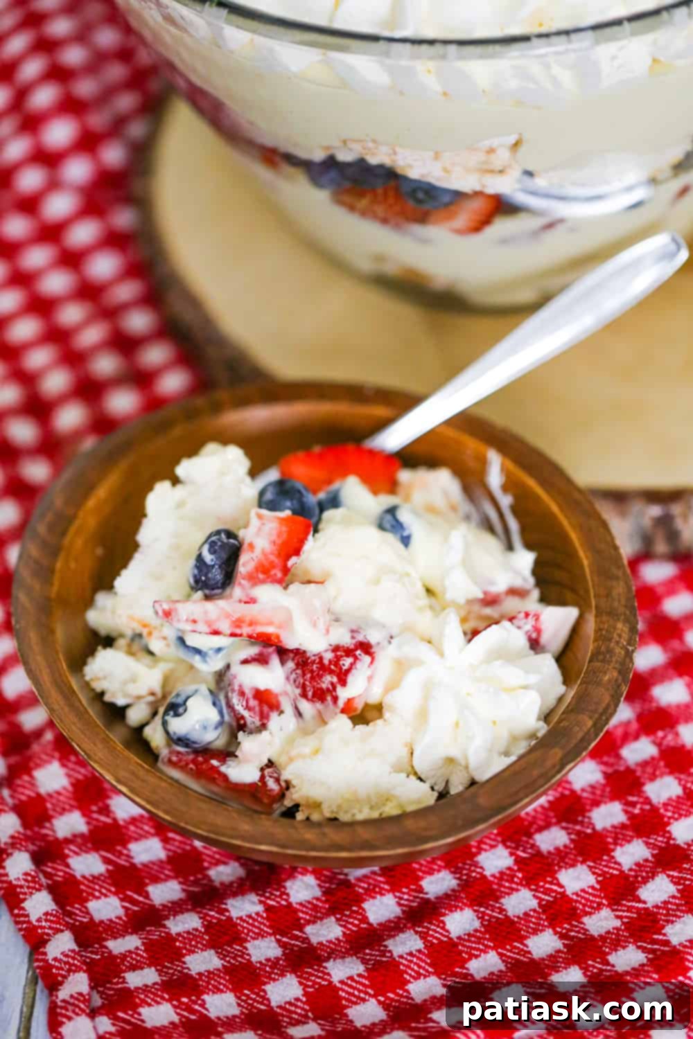 Full view of the Easy Berry Trifle, a layered dessert with angel food cake, berries, and cream in a glass dish.