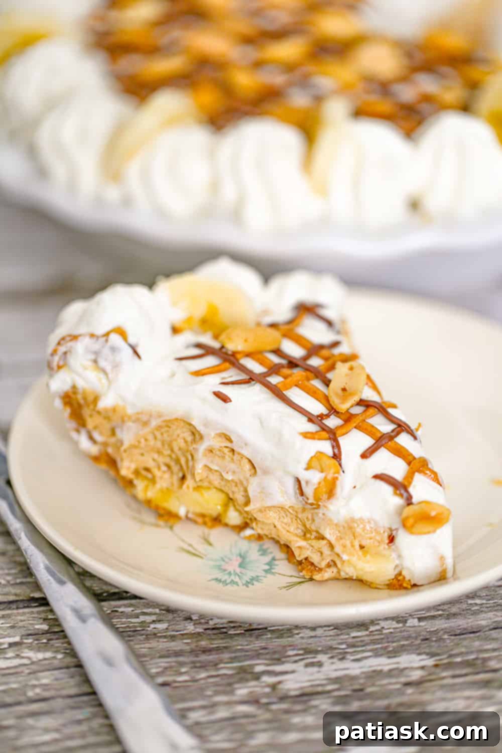 Layers of creamy no-bake peanut butter banana pie in a pie dish