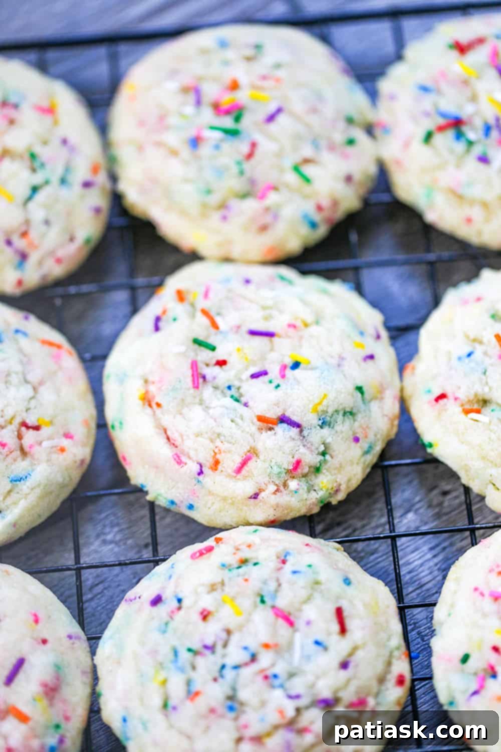 Multiple sprinkle sugar cookies arranged artfully, showcasing their vibrant colors