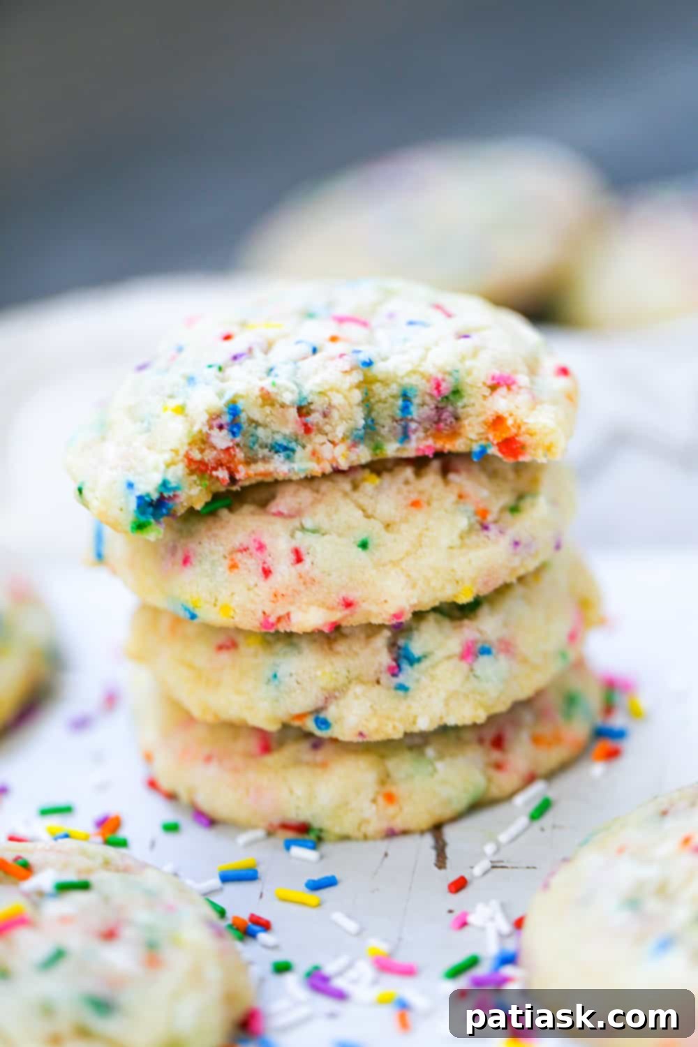 Close-up of a sprinkle sugar cookie showing its soft interior and vibrant sprinkles