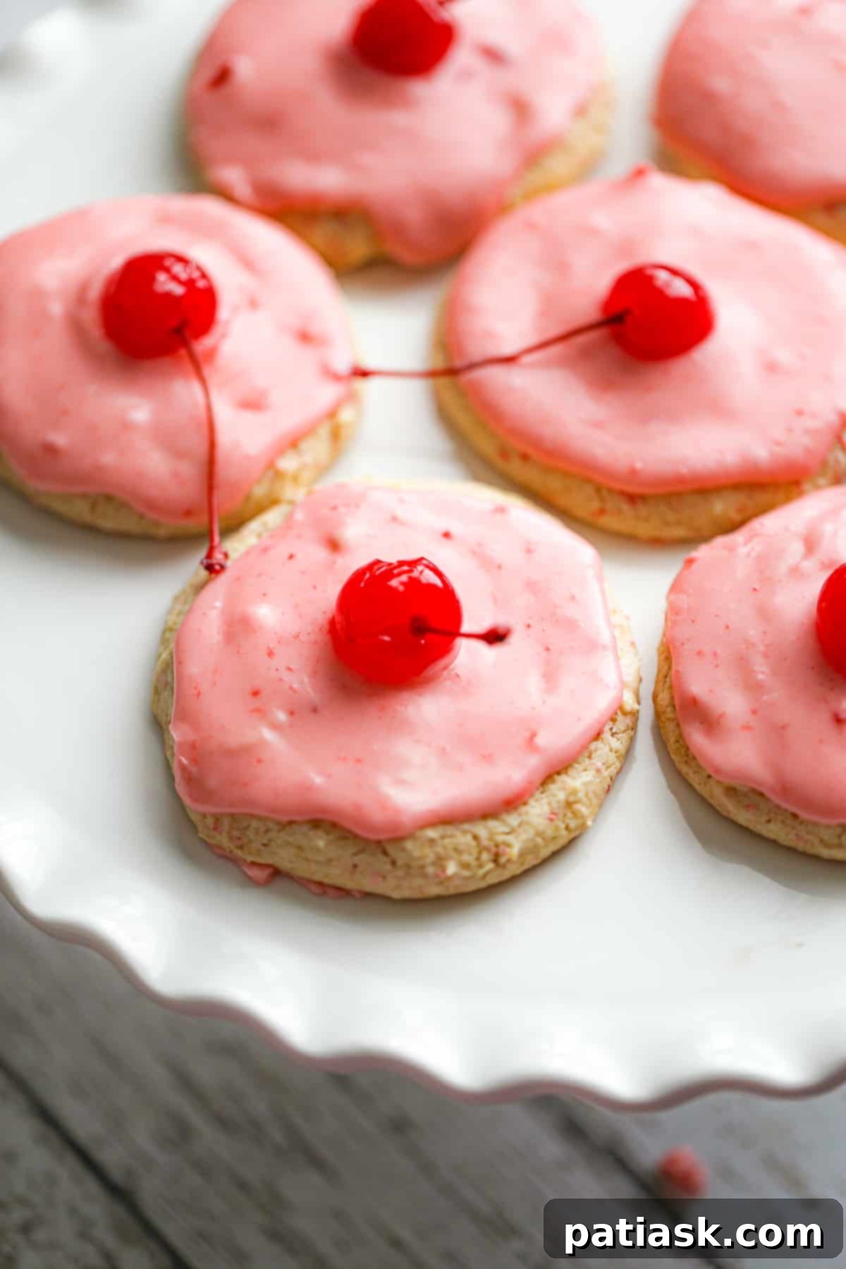 Sweet Cherry Chip Cookies 5 Freshly baked Cherry Chip Cookies generously topped with vibrant pink maraschino cherry glaze on a cooling rack