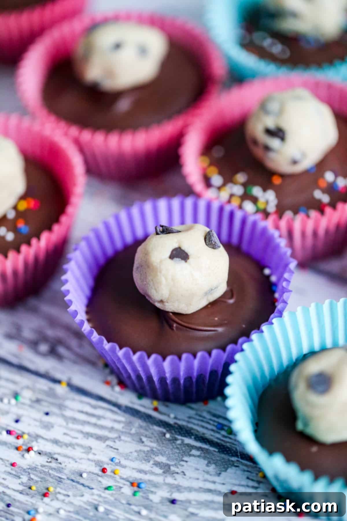 No-Bake Cookie Dough Delights 8 A batch of completed No Bake Cookie Dough Truffle Cups beautifully displayed in individual liners