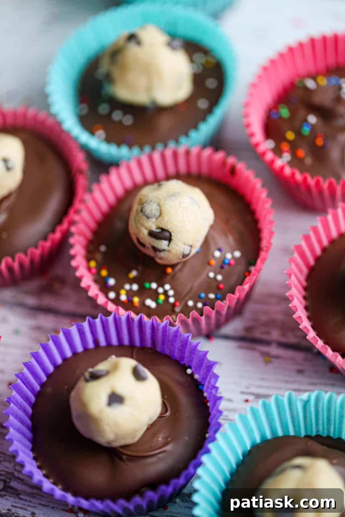 No-Bake Cookie Dough Delights 3 Close-up of a No Bake Cookie Dough Truffle Cup revealing the textured cookie dough center and chocolate layers