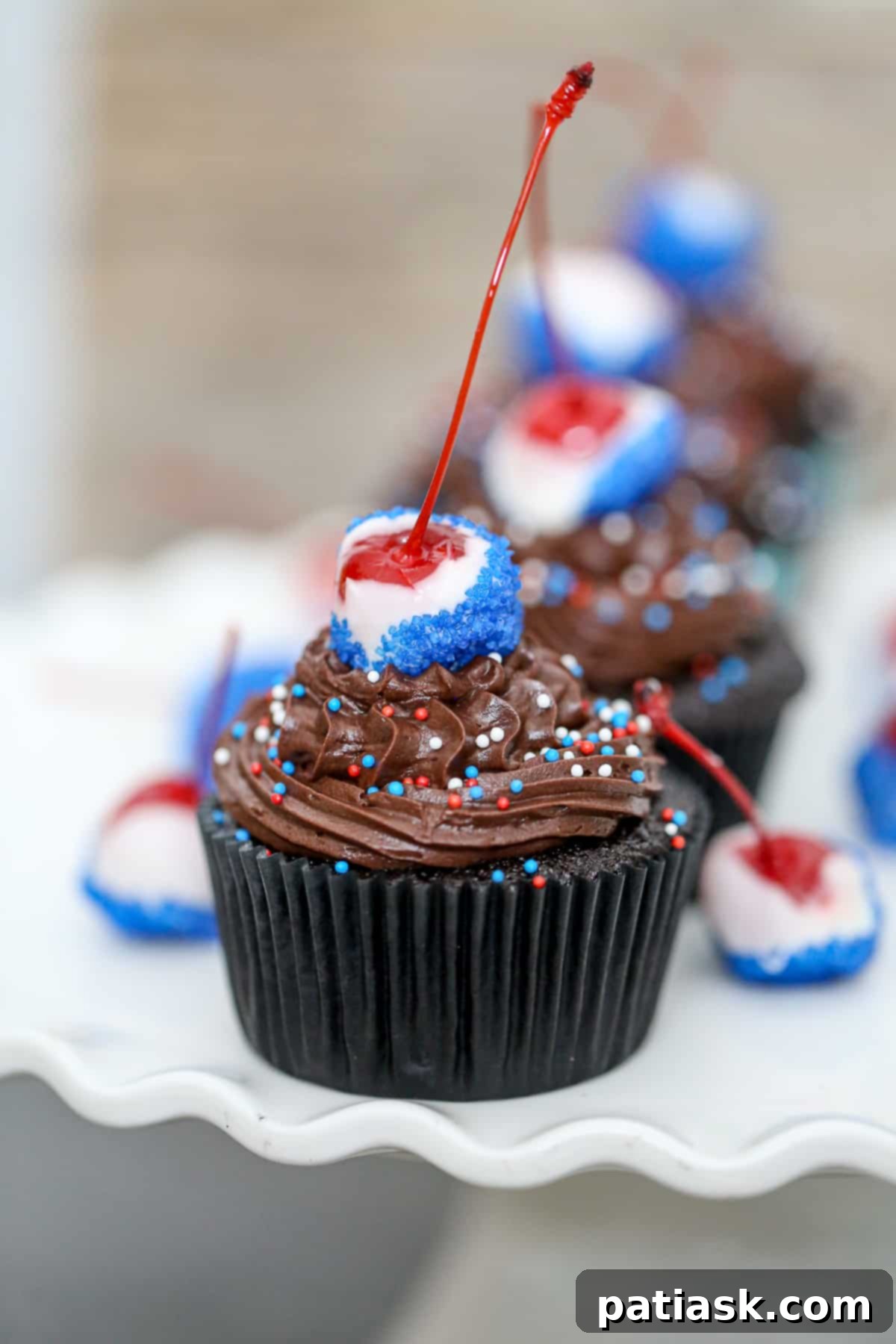 Patriotic Cherry Bomb Cupcakes 4 Close-up of a 4th of July Cherry Bomb Cupcake with chocolate-covered cherry