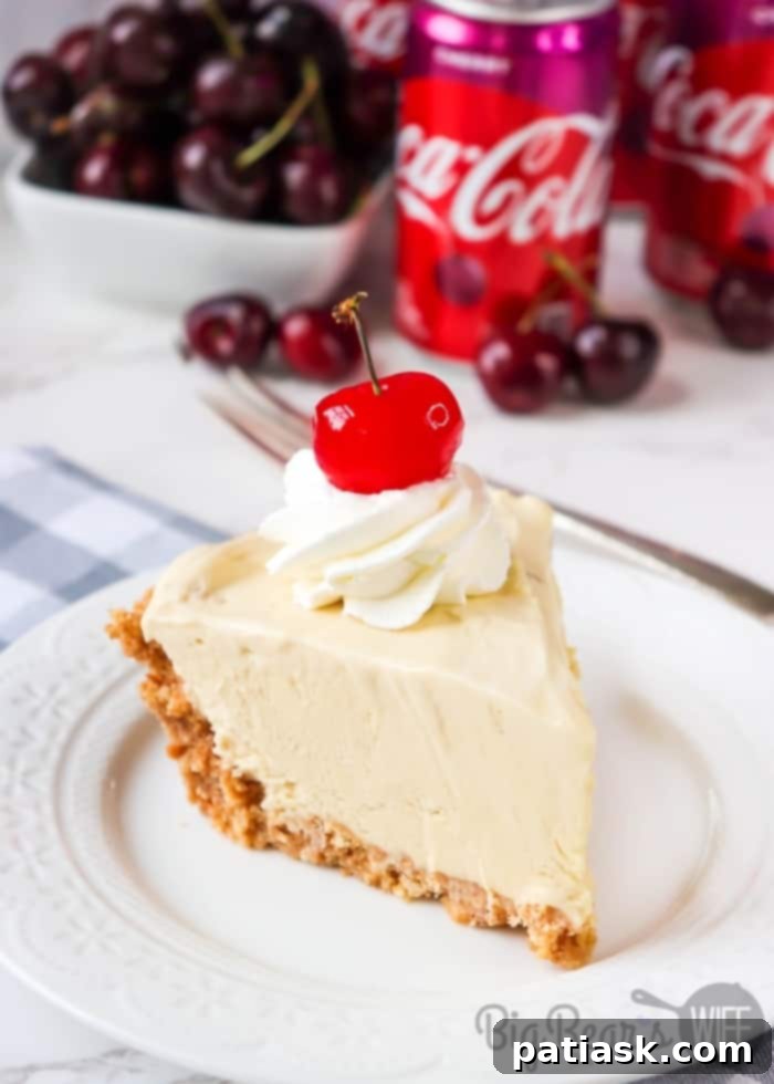 50 Sublime Ice Cream Treats to Savor This Summer 4 A tempting slice of Cherry Coke Float Pie served on a white plate, showcasing its layers.