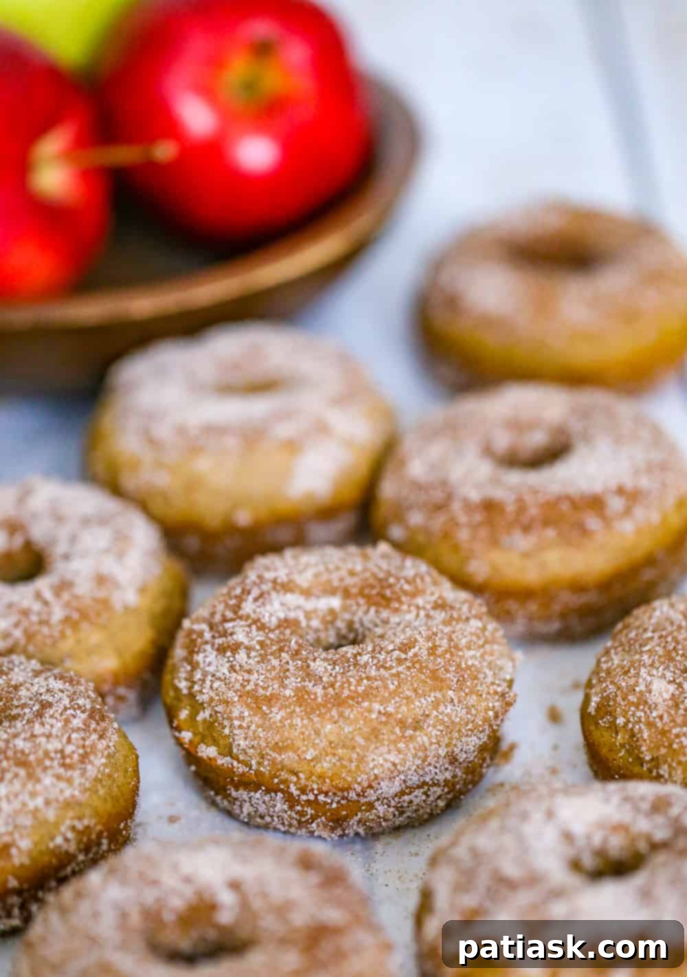 Warm Apple Cinnamon Baked Donuts 3 baked apple donuts with cinnamon sugar