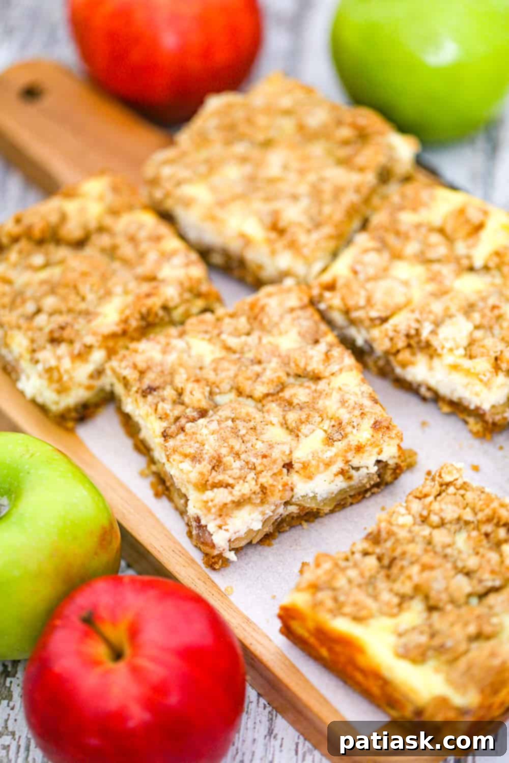 Autumn Apple Crumble Cheesecake Squares 3 Closeup of apple cheesecake bars, showcasing the golden oat topping and creamy filling