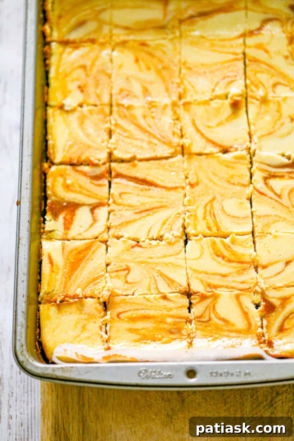 Effortless Pumpkin Cheesecake Bars 6 Pumpkin Cheesecake Bars baking in a pan, showing the swirl effect.