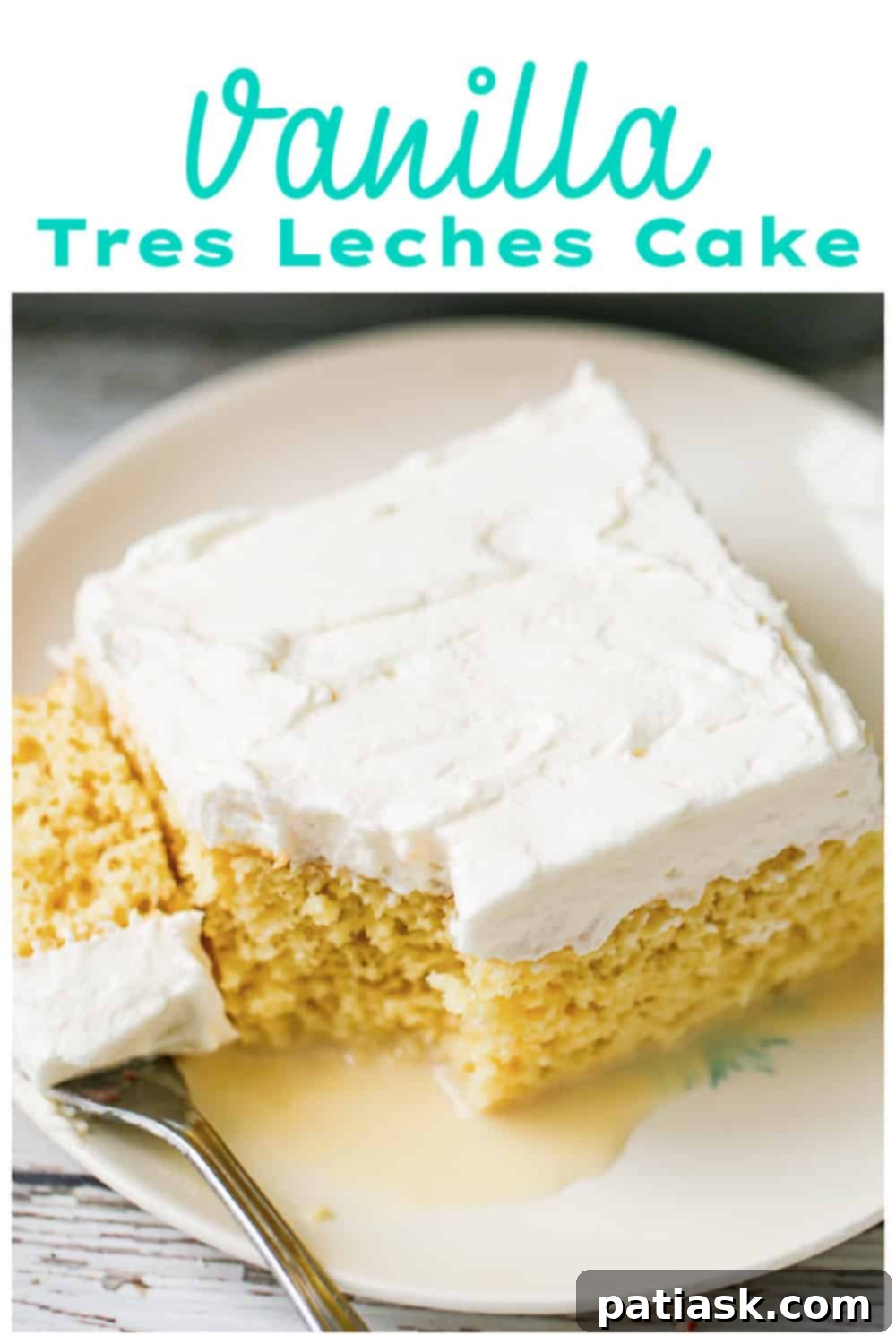 Close-up of Vanilla Tres Leches Cake slice with creamy topping