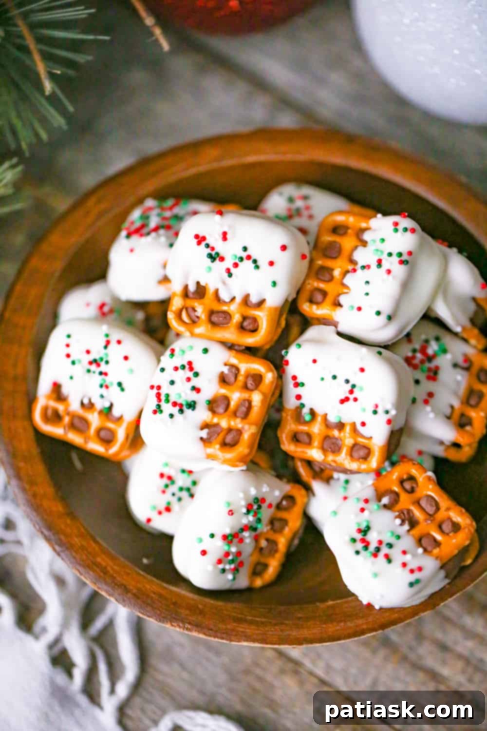 White Chocolate Pretzel Rolo Delights 6 Hands holding a White Chocolate Pretzel Rolo Bite