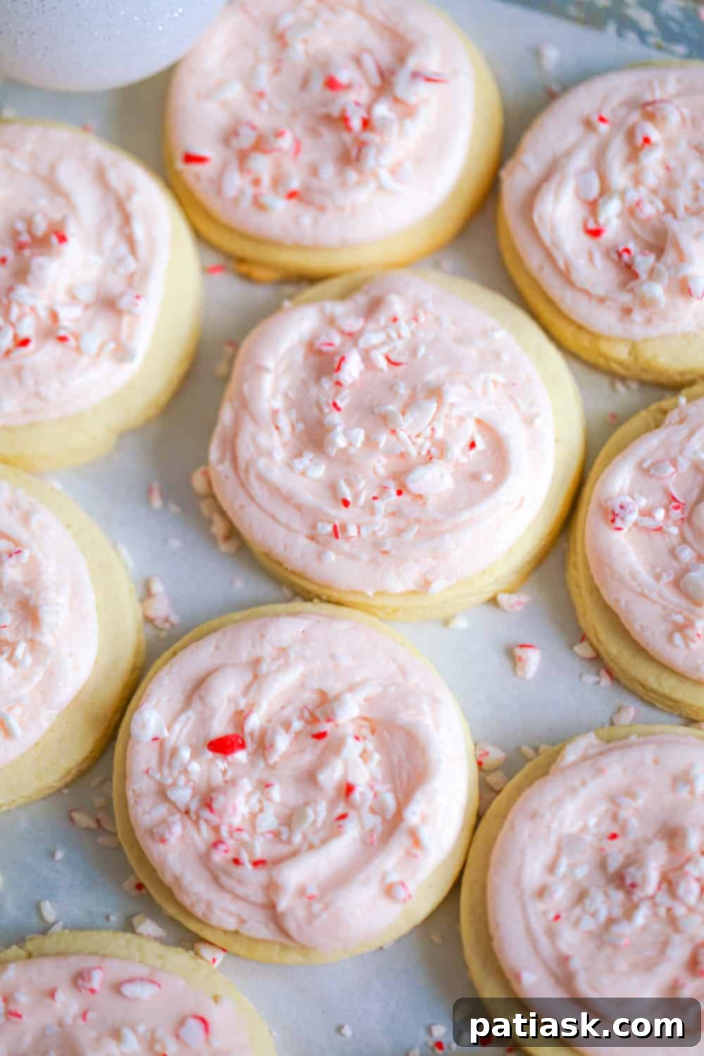 Peppermint Swirl Cookies 8 A final close-up of a single frosted candy cane cookie, emphasizing its texture and festive appeal.