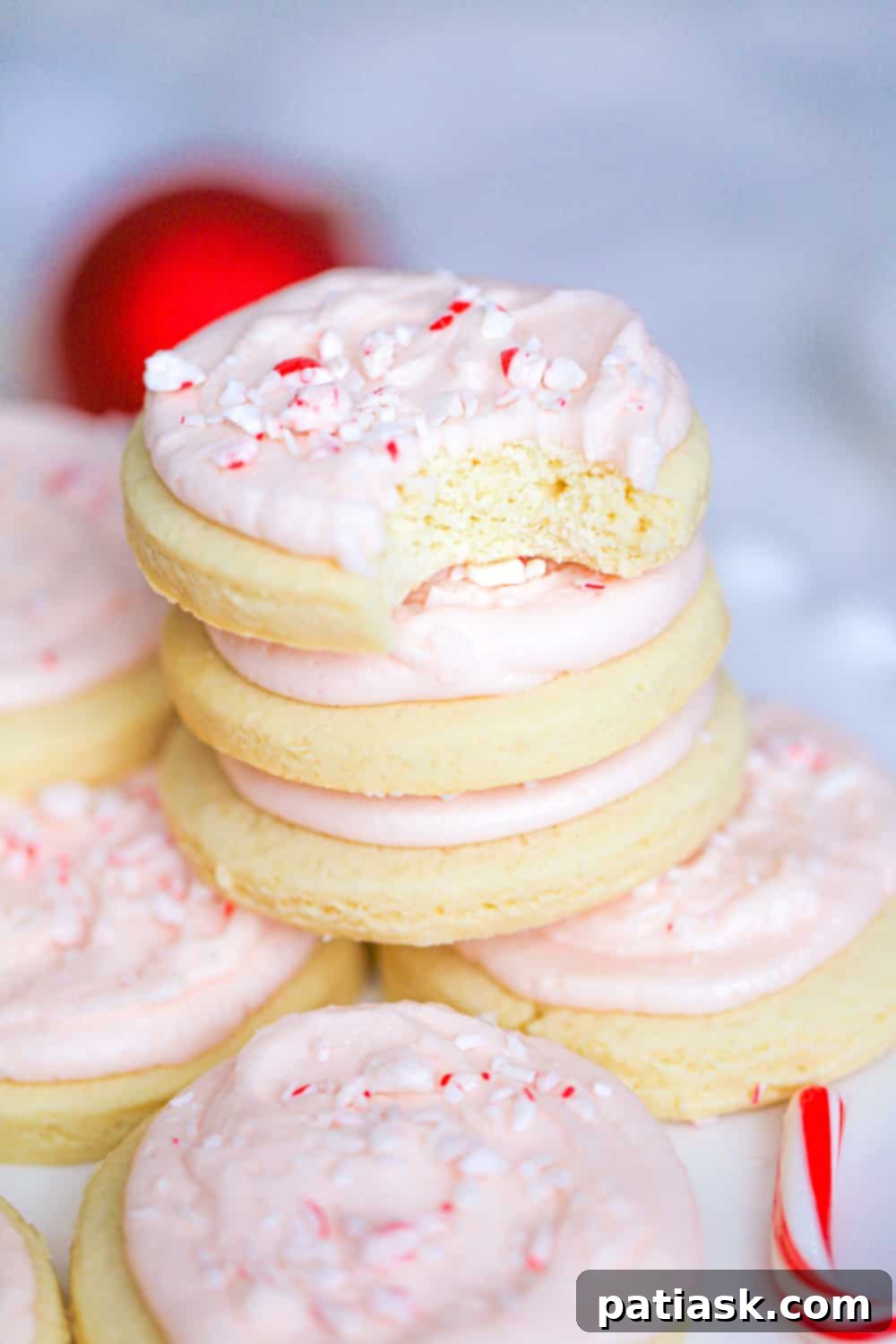 Peppermint Swirl Cookies 4 Stack of four beautiful candy cane frosted cookies, showing the fluffy frosting and crushed candy cane topping.